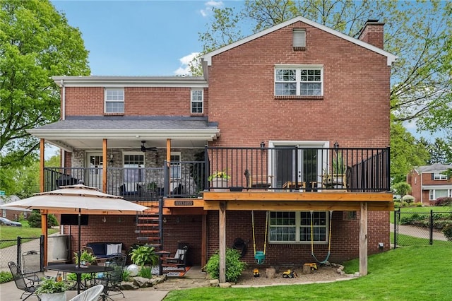 back of house featuring a chimney, a patio, brick siding, ceiling fan, and stone siding