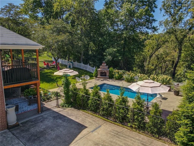 view of pool featuring an outdoor fireplace, a patio area, and a gazebo