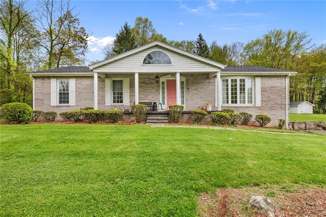 single story home featuring a porch, brick siding, and a front yard