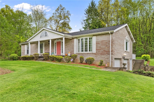 view of front of property featuring covered porch, an attached garage, brick siding, and a front lawn