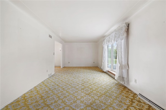 spare room featuring a baseboard radiator, carpet flooring, and baseboards