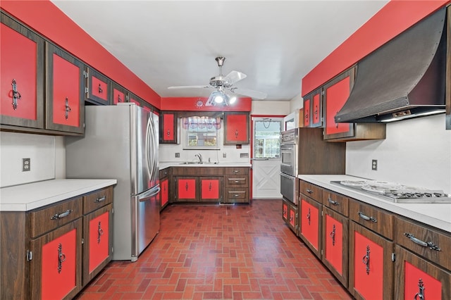 kitchen featuring extractor fan and red cabinetry