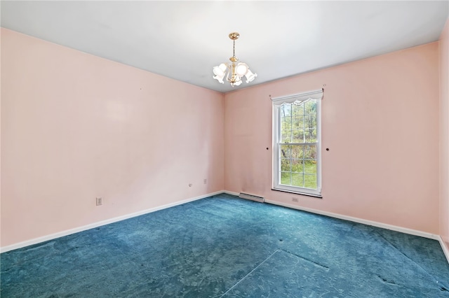 empty room featuring carpet, a chandelier, and baseboards