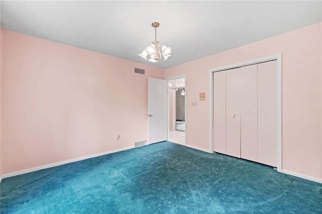 unfurnished bedroom featuring a chandelier, baseboards, carpet, and a closet