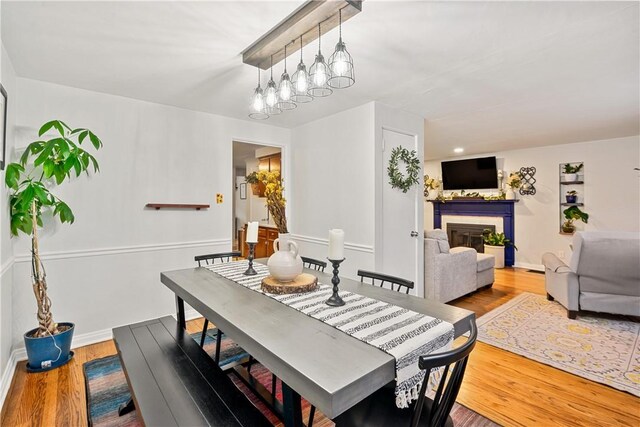 1009 Connor Rd, Castle Shannon, PA 15234 - dining room featuring a glass covered fireplace, wood finished floors, and baseboards