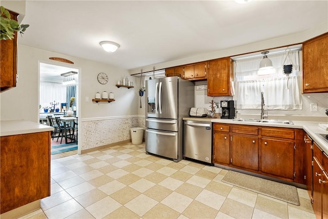 1009 Connor Rd, Castle Shannon, PA 15234 - kitchen featuring stainless steel appliances, a sink, plenty of natural light, a wainscoted wall, and light countertops