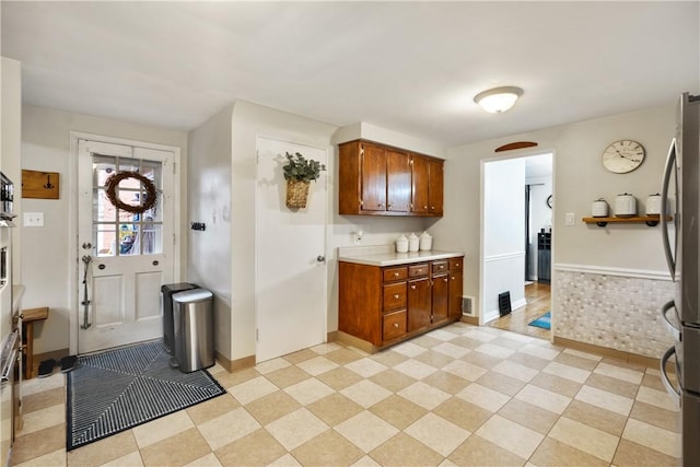 1009 Connor Rd, Castle Shannon, PA 15234 - kitchen featuring freestanding refrigerator, light countertops, brown cabinets, and baseboards