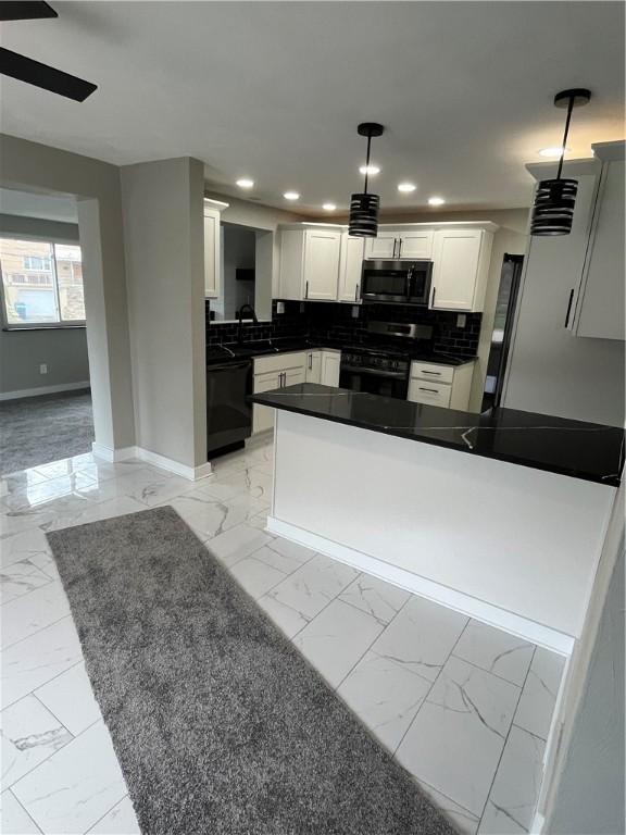 kitchen featuring black range with gas stovetop, light marble finish floors, stainless steel microwave, dishwasher, and baseboards