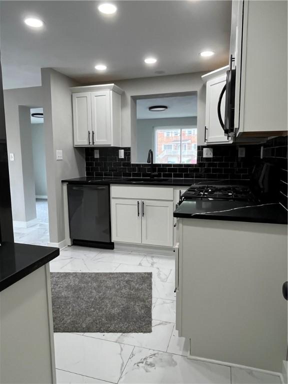 kitchen with dishwasher, a sink, dark countertops, light marble finish flooring, and recessed lighting