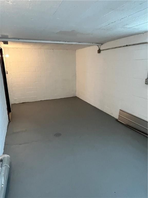 finished below grade area featuring concrete block wall