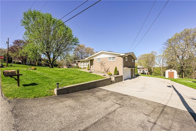view of home's exterior with a shed, an attached garage, driveway, a yard, and an outbuilding