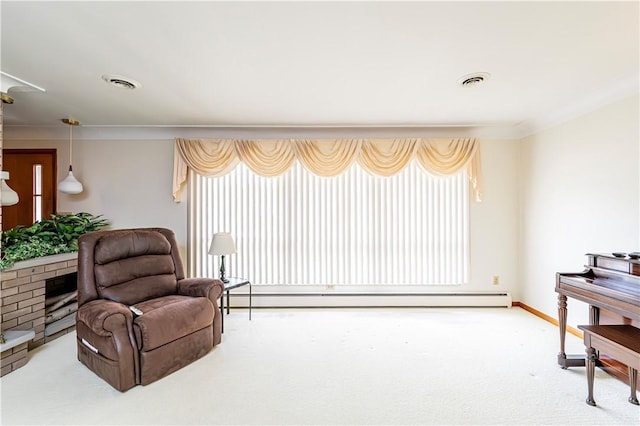 sitting room with a baseboard heating unit, carpet flooring, and baseboards