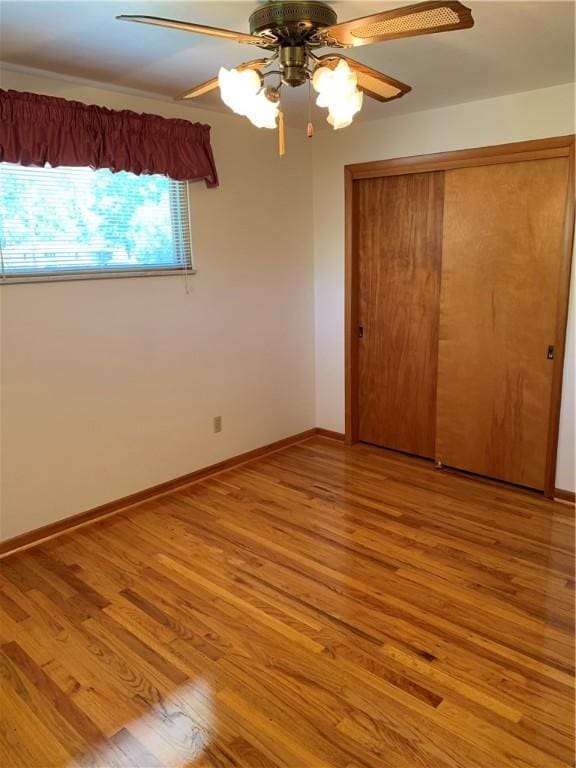 626 Woodburn Ln, Hempfield Twp Wml, PA 15601 - unfurnished bedroom featuring light wood finished floors, a ceiling fan, a closet, and baseboards