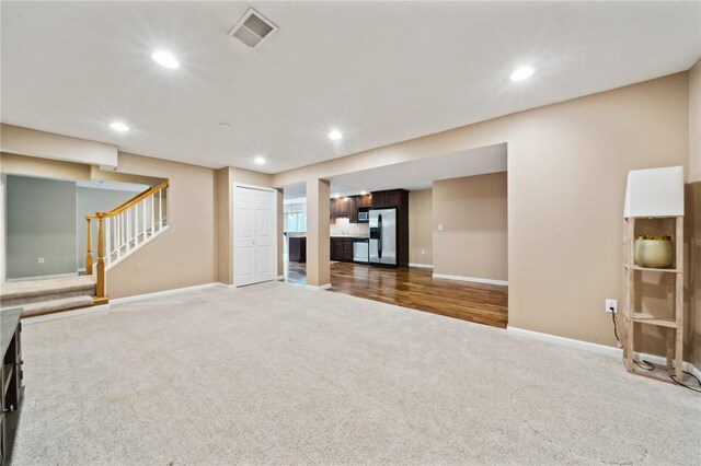 430 Southfield Dr, Hempfield Twp Wml, PA 15601 - unfurnished living room with carpet flooring, baseboards, recessed lighting, and stairs