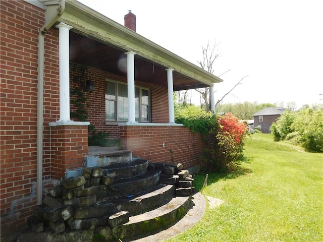 110 Holbert Stretch Rd, Bobtown/Dilliner, PA 15327 - view of property exterior with a lawn, brick siding, and covered porch