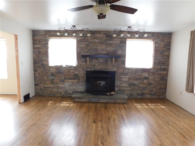 110 Holbert Stretch Rd, Bobtown/Dilliner, PA 15327 - unfurnished living room featuring a wood stove, a ceiling fan, and wood finished floors