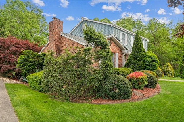 620 Sandy Hill Rd, Manor, PA 15642 - view of property exterior featuring a chimney, a lawn, and brick siding