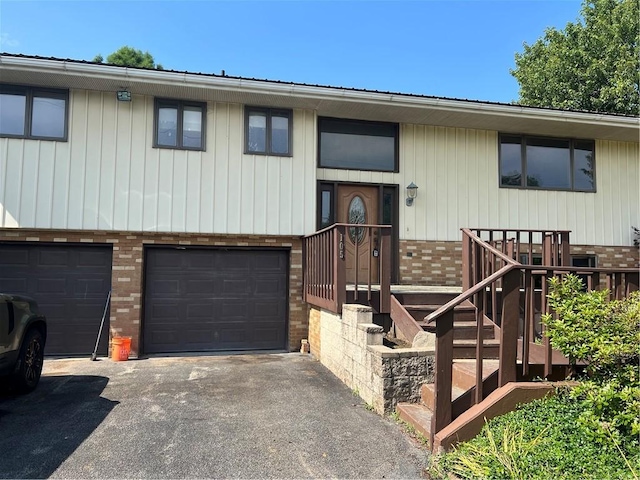 105 Lawrence Ave, Twp Of But Nw, PA 16001 - bi-level home featuring brick siding, an attached garage, and asphalt driveway