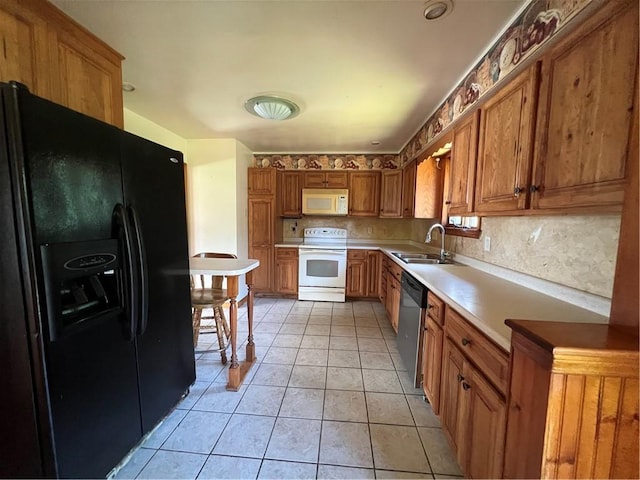 105 Lawrence Ave, Twp Of But Nw, PA 16001 - kitchen with white appliances, brown cabinetry, light countertops, backsplash, and light tile patterned floors