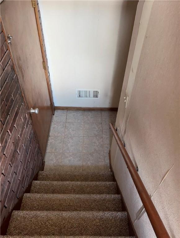 105 Lawrence Ave, Twp Of But Nw, PA 16001 - stairs featuring baseboards and tile patterned flooring