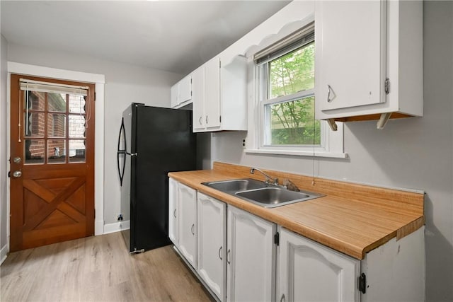 1534 Dormont Ave, Dormont, PA 15216 - kitchen featuring freestanding refrigerator, a sink, white cabinetry, light wood-type flooring, and light countertops