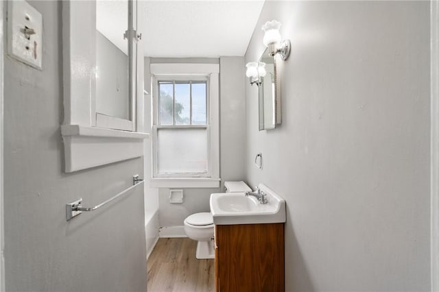 1534 Dormont Ave, Dormont, PA 15216 - full bath featuring toilet, wood finished floors, baseboards, a tub to relax in, and vanity