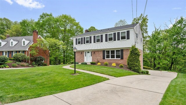 2023 Menold Dr, Mccandless, PA 15101 - colonial home featuring a front yard, brick siding, and a chimney