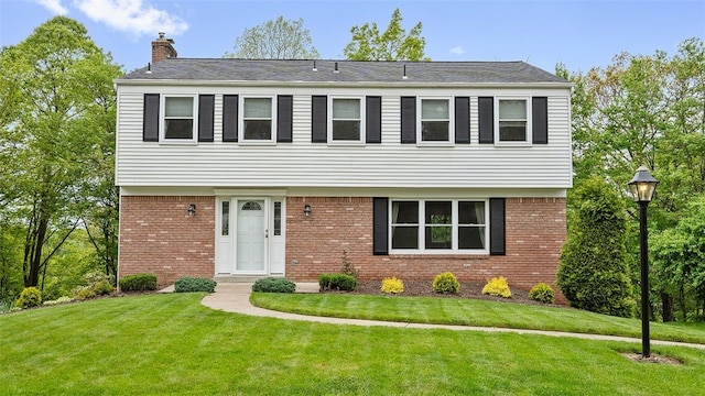 2023 Menold Dr, Mccandless, PA 15101 - colonial home with brick siding, a chimney, and a front yard
