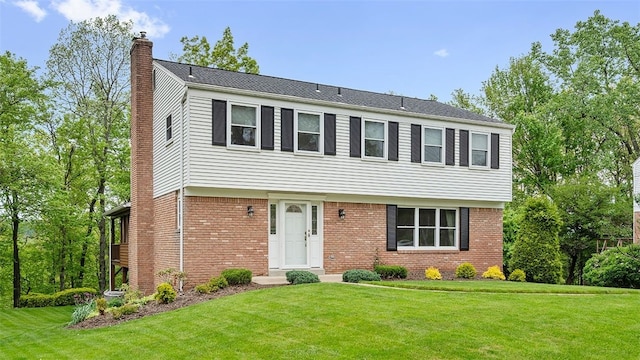 2023 Menold Dr, Mccandless, PA 15101 - colonial house with a chimney, a front lawn, and brick siding
