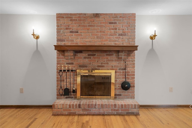 2023 Menold Dr, Mccandless, PA 15101 - detailed view of baseboards, a brick fireplace, and wood finished floors