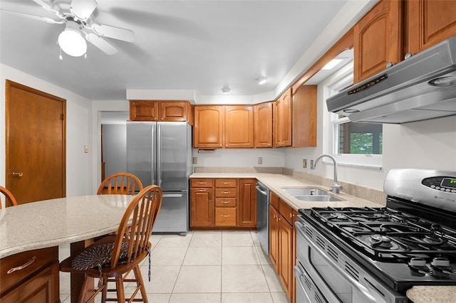 2023 Menold Dr, Mccandless, PA 15101 - kitchen with stainless steel appliances, under cabinet range hood, a sink, brown cabinets, and light tile patterned flooring