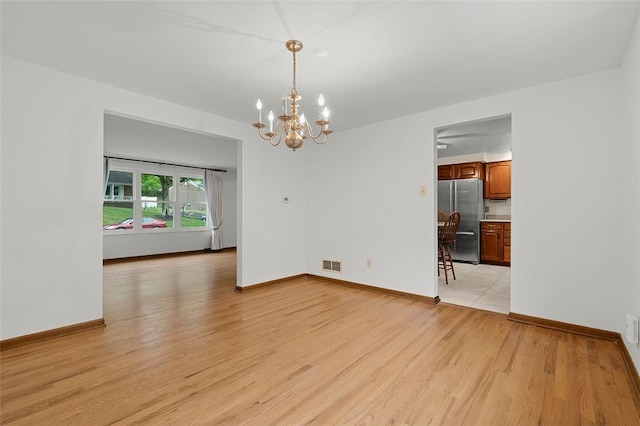 2023 Menold Dr, Mccandless, PA 15101 - unfurnished dining area featuring a chandelier, light wood-style floors, and baseboards