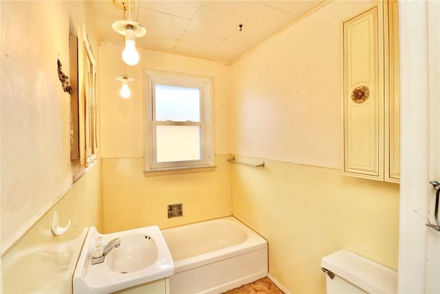 bathroom featuring a sink, toilet, and a tub