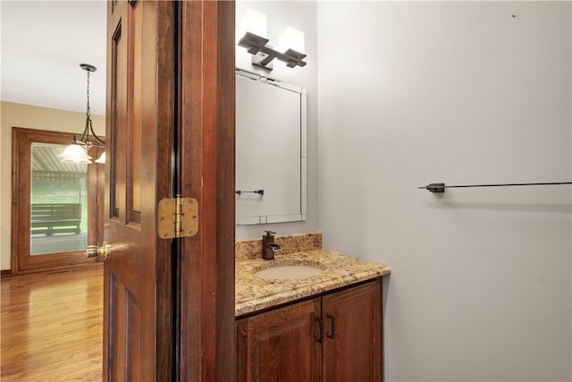 bathroom with wood finished floors and vanity