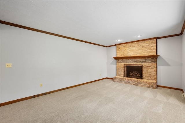 unfurnished living room featuring crown molding, carpet flooring, baseboards, a brick fireplace, and recessed lighting