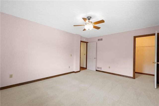 unfurnished room with a ceiling fan, baseboards, and light carpet