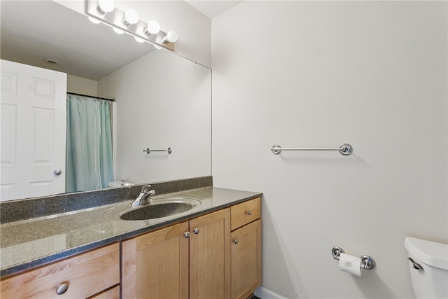 bathroom featuring toilet and vanity
