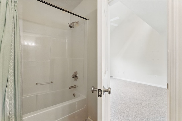 full bath with baseboards and shower / bath combo