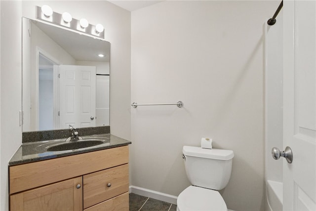 bathroom with toilet, vanity, tile patterned flooring, and baseboards