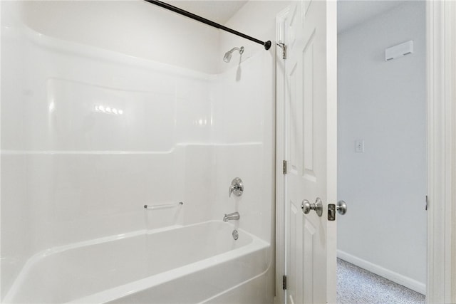 bathroom with baseboards and shower / bath combination