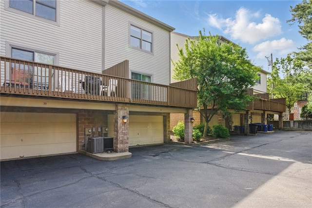 back of property with a balcony and an attached garage