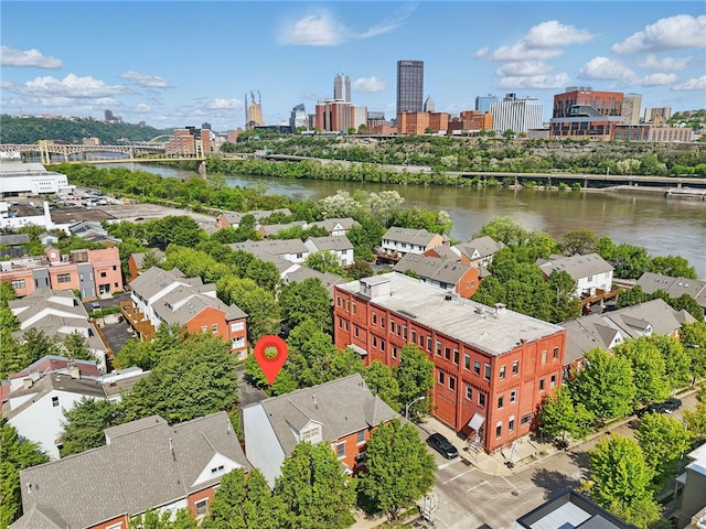 aerial view of a notable bridge, a large body of water, and a view of skyline