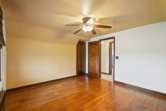 spare room with ceiling fan, baseboards, and wood finished floors