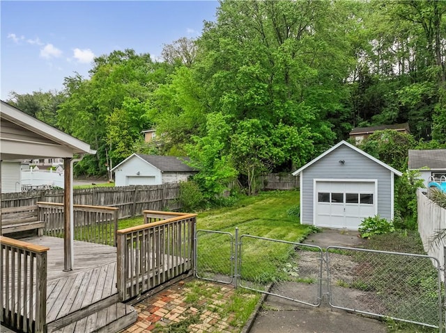 813 11th Ave, New Brighton, PA 15066 - view of yard with a detached garage, concrete driveway, a gate, an outbuilding, and a wooden deck