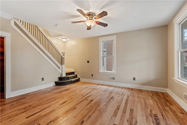813 11th Ave, New Brighton, PA 15066 - unfurnished living room featuring light wood finished floors, ceiling fan, stairway, and baseboards