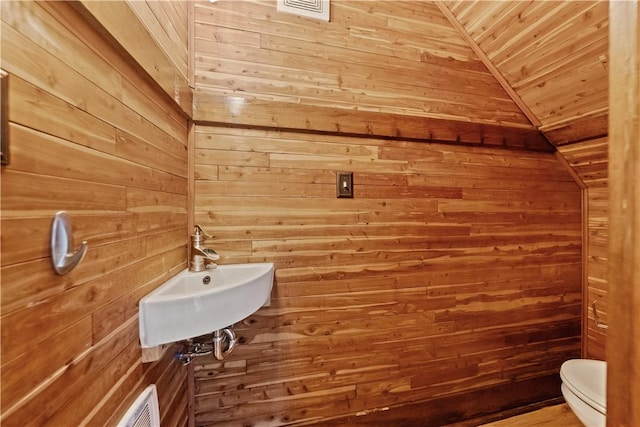 813 11th Ave, New Brighton, PA 15066 - bathroom featuring wood walls, a sink, toilet, wood ceiling, and lofted ceiling
