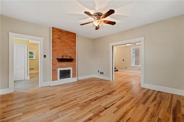 813 11th Ave, New Brighton, PA 15066 - unfurnished living room with a ceiling fan, light wood-style floors, baseboards, and a fireplace