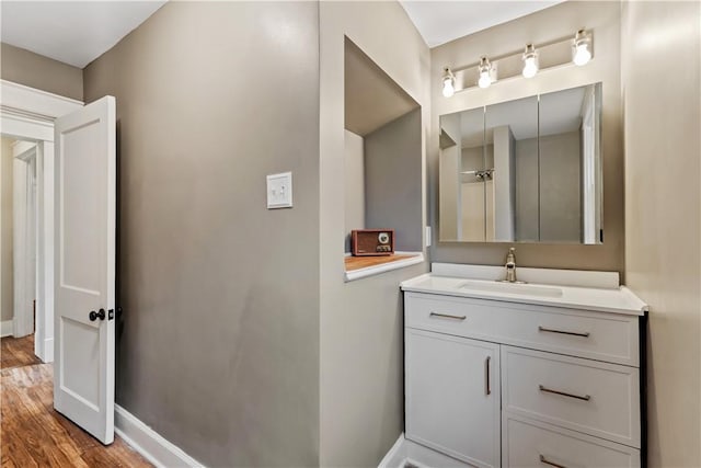813 11th Ave, New Brighton, PA 15066 - bathroom with wood finished floors, vanity, and baseboards