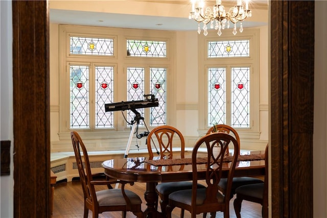 6020 Grafton St, Highland Park, PA 15206 - dining space with a chandelier, dark wood-type flooring, radiator heating unit, and plenty of natural light