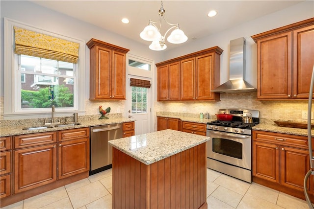 6020 Grafton St, Highland Park, PA 15206 - kitchen with stainless steel appliances, wall chimney range hood, a chandelier, light tile patterned floors, and recessed lighting
